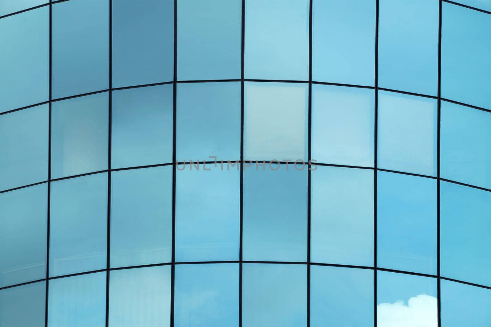 clouds reflected in the glass facade of a skyscraper by Annado