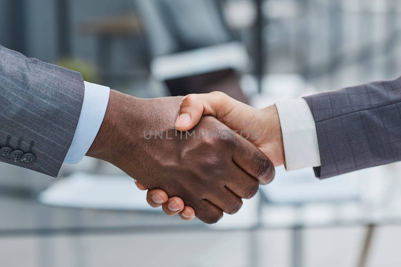 Business shaking hands, finishing up meeting. Successful businessmen handshaking after good deal by Prosto