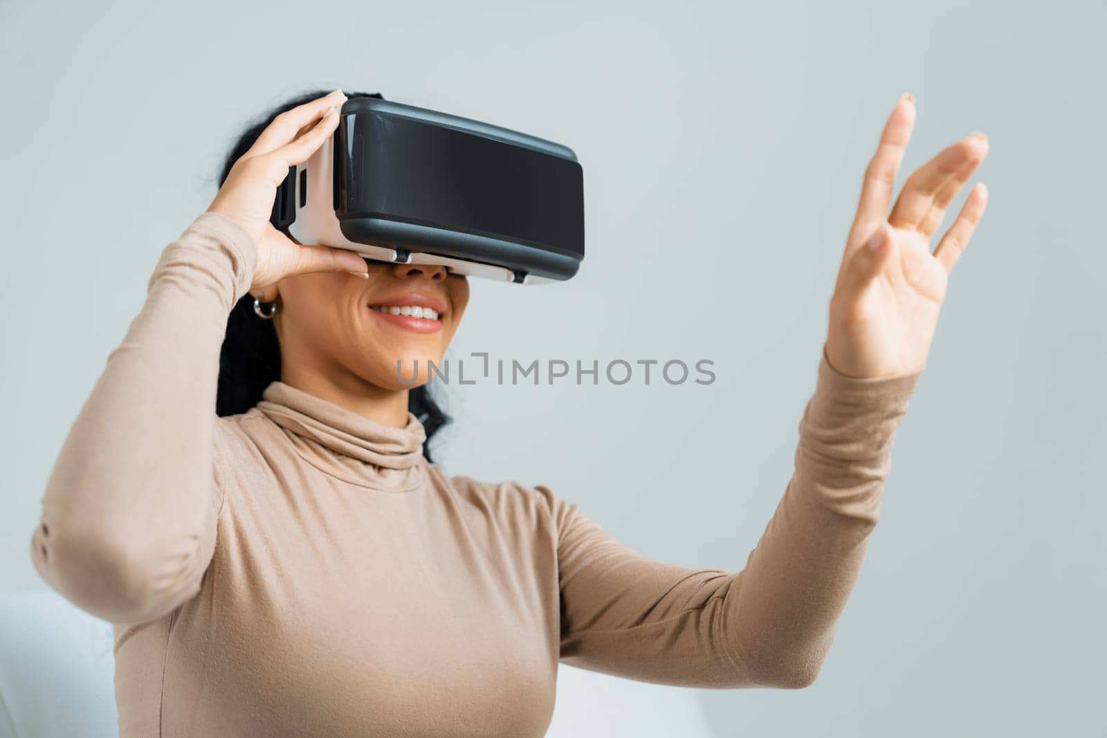 Young woman using virtual reality VR goggle at home for crucial online shopping experience. The virtual reality VR innovation optimized for female digital entertainment lifestyle.