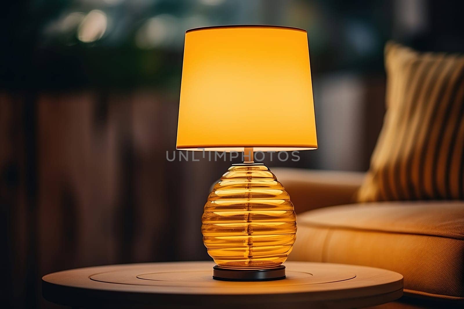 Yellow table lamp on a wooden surface, cozy warm light.