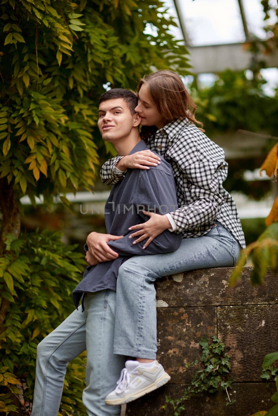 Love's Moments: A Young Cute Female Hugs Her Boyfriend in the Enchanting Autumn Park - A Lovestory Unfolding. Young Cute Female Hugs Boyfriend. In Autumn Outdoor. Lovers Walking in Park. Attractive Funny Couple. Lovestory in Forest. Man and Woman. Cute Lovers in the Park. Family Concept. Happy Couple. by Andrii_Ko