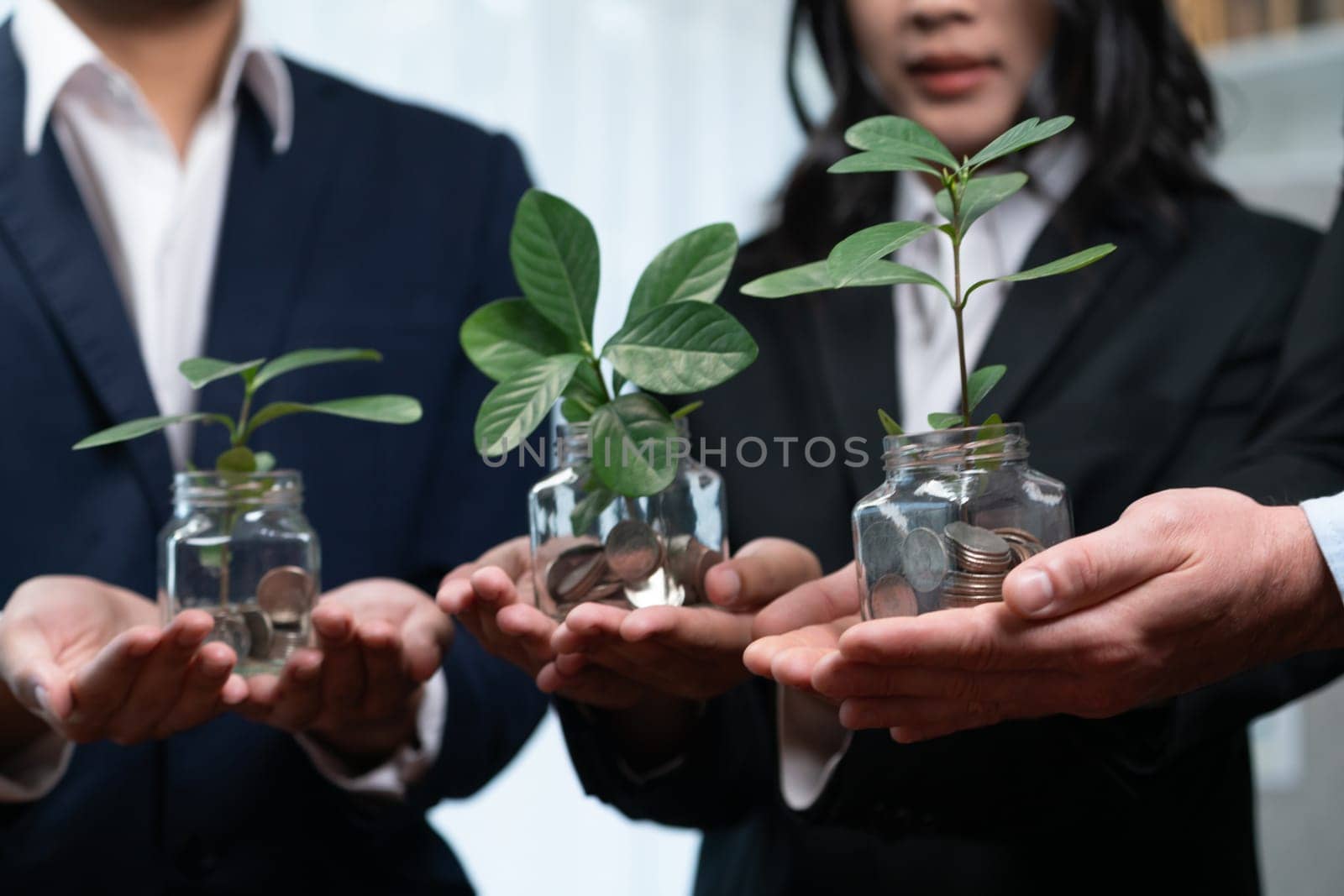 Business people holding money savings jar filled with coins and growing plant for sustainable financial planning for retirement or eco subsidy investment for environment protection. Quaint