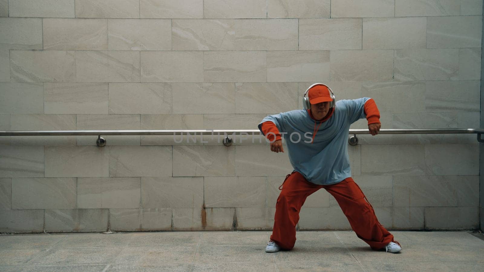 Handsome choreographer practice street dance in gray background. Sprightly. by biancoblue