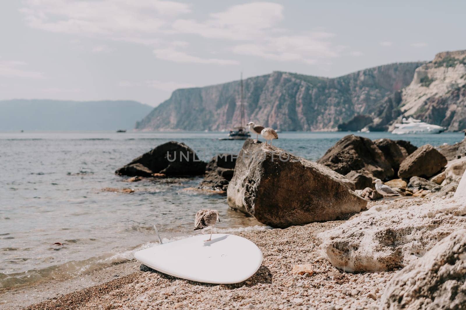 Woman summer travel sea. Happy tourist enjoy taking picture outdoors for memories. Woman traveler posing on the beach at sea surrounded by volcanic mountains, sharing travel adventure journey by panophotograph