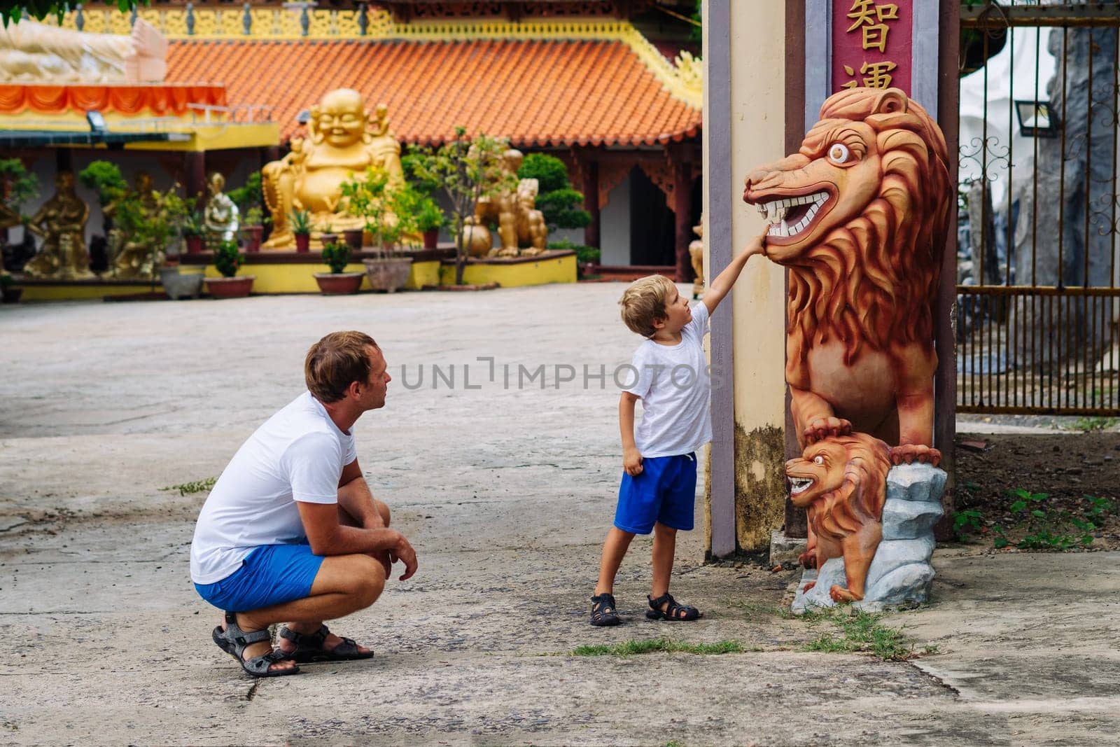 Father and son tourists walking in Vietnam Buddhist Temple, happy childhood, exploring world.