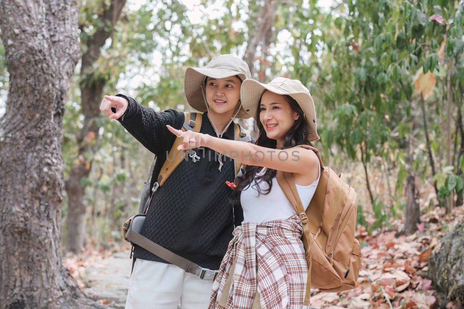 A happy Asian couple spends their free time together on a scenic hiking trip..