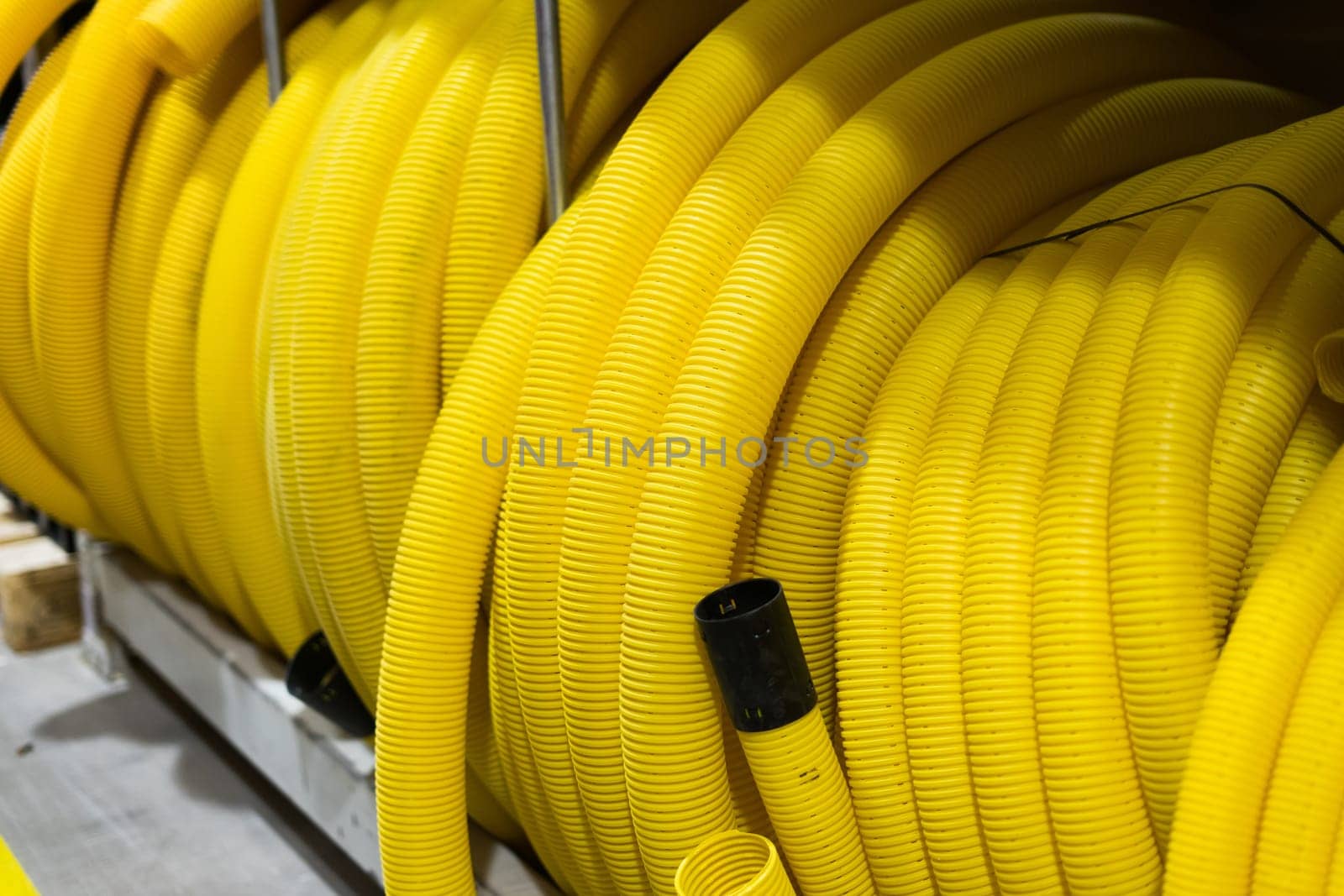 Large roll of a plastic corrugated pipe for insulating electrical wires
