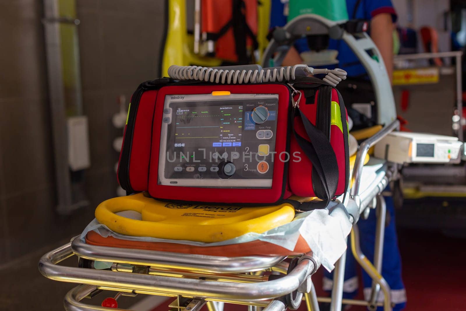 Moscow, Moscow region, Russia - 03.09.2023:Emergency medical monitor and defibrillator on a stretcher with CPR board in an ambulance by Zakharova