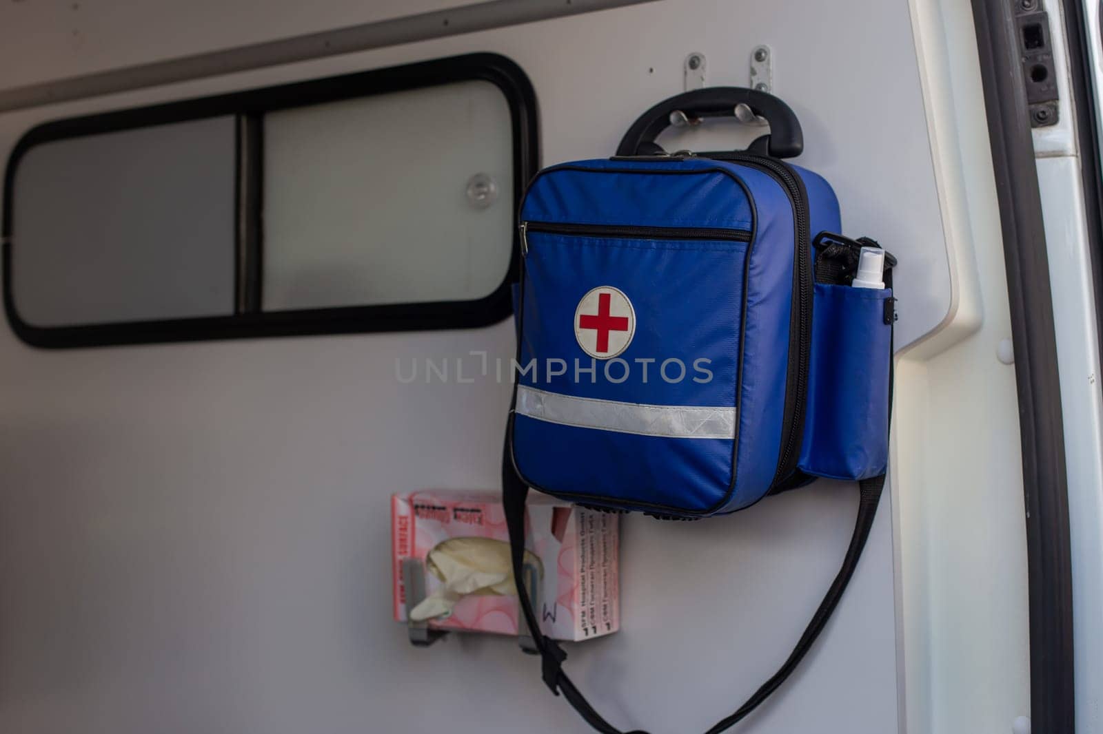 Moscow, Moscow region, Russia - 03.09.2023:A blue medical bag with a red cross and emergency equipment mounted inside an ambulance