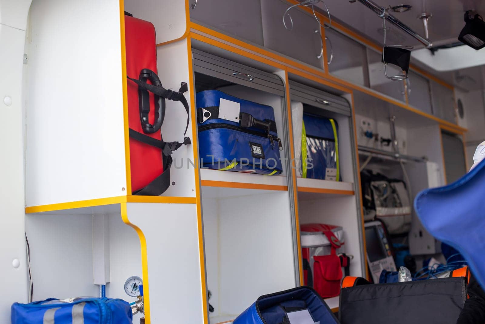 Inside of an ambulance showing medical supplies and storage compartments.