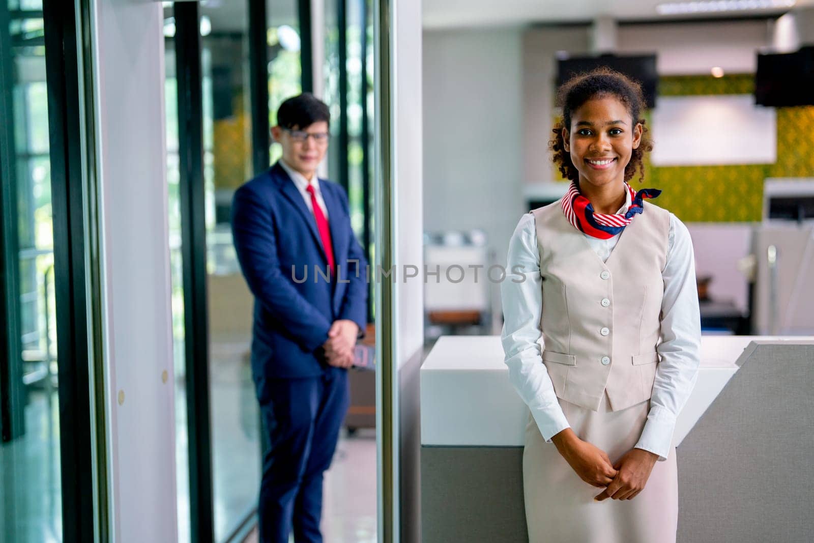 Portrait of air hostess and airline staff at gate of airport to welcome and check the security of passenger before go inside of transportation by airplane.