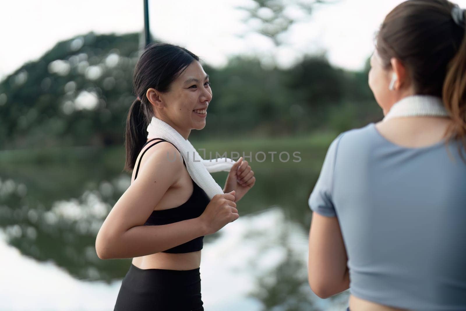 female friend go to exercise together at village park in evening, working out for health by itchaznong