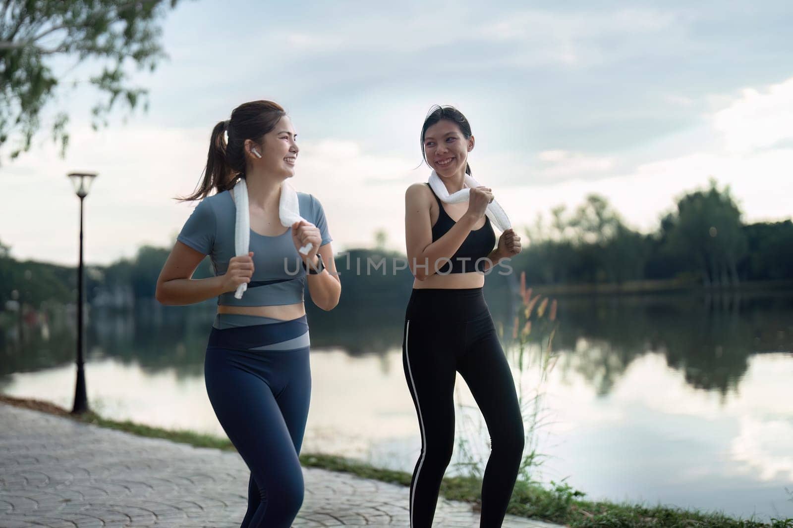 female friend go to exercise together at village park in evening, working out for health by itchaznong