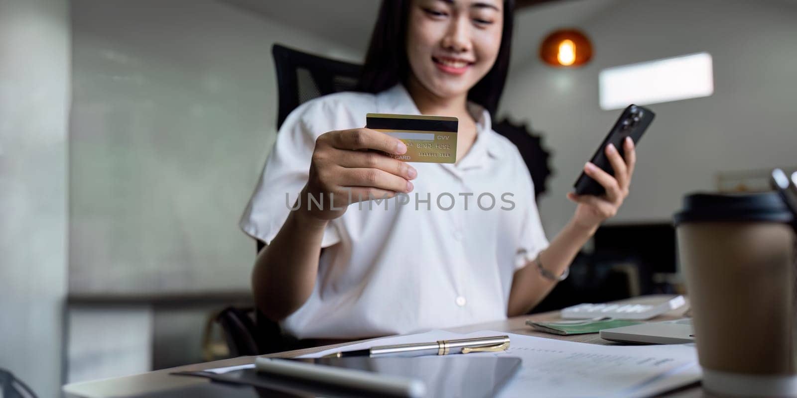 female using mobile telephone to make easy safe payment online in electronic bank system. Young lady client spend money from credit card by itchaznong