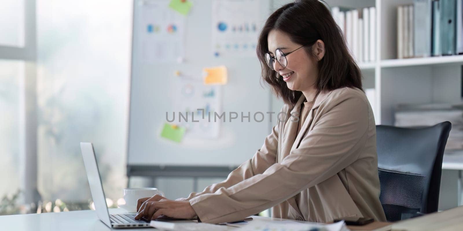 businesswoman working about project with laptop computer and papers working at office. copy space.