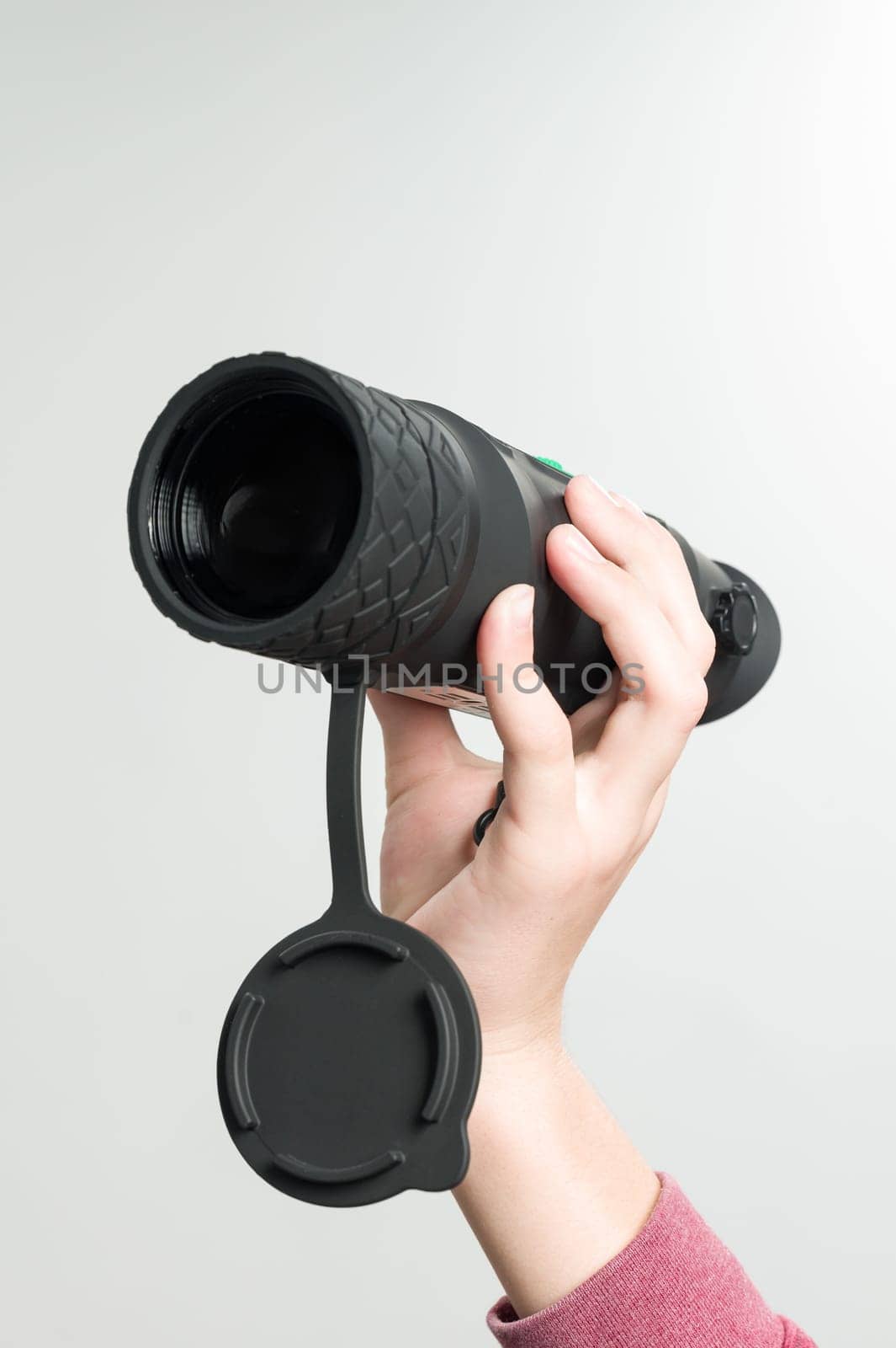 A child holds a monocular in his hand on a white background. by Niko_Cingaryuk