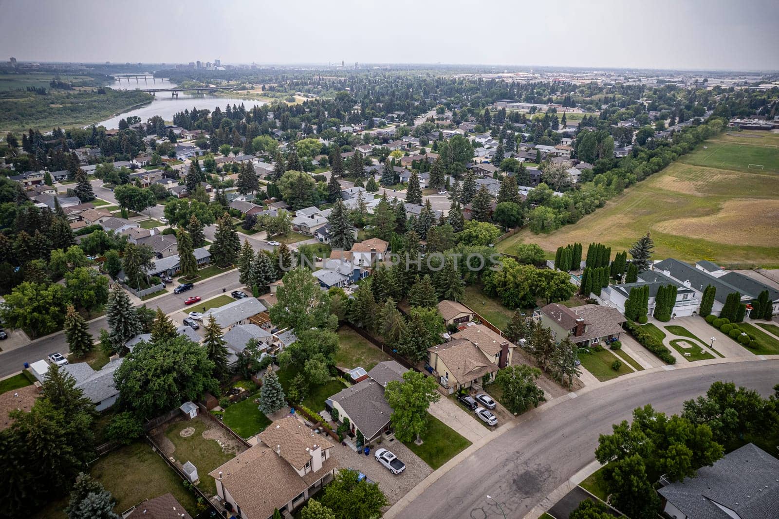 Drone image capturing the charm of River Heights, Saskatoon, with its lush landscapes and residential areas.