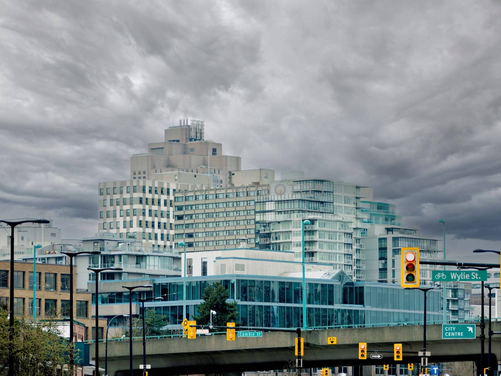 View at residetial and office buildings in Vancouver on overcast sky background.