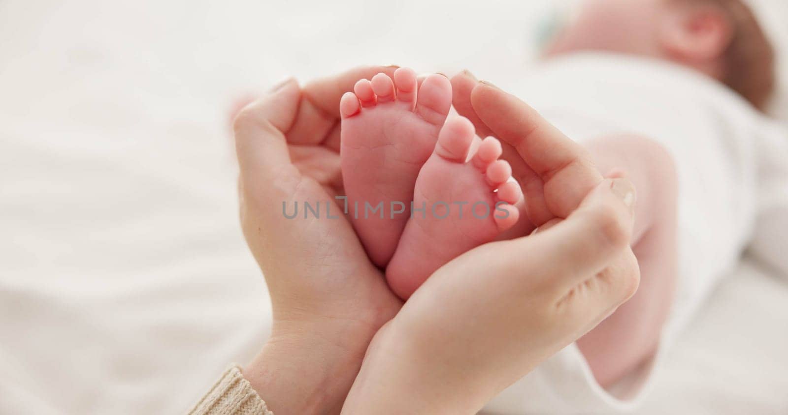 Feet, hands and mother with baby, love and support for care, health and wellness in bedroom. Closeup, family or mama with an infant, protection and child development with bonding or maternity in home by YuriArcurs