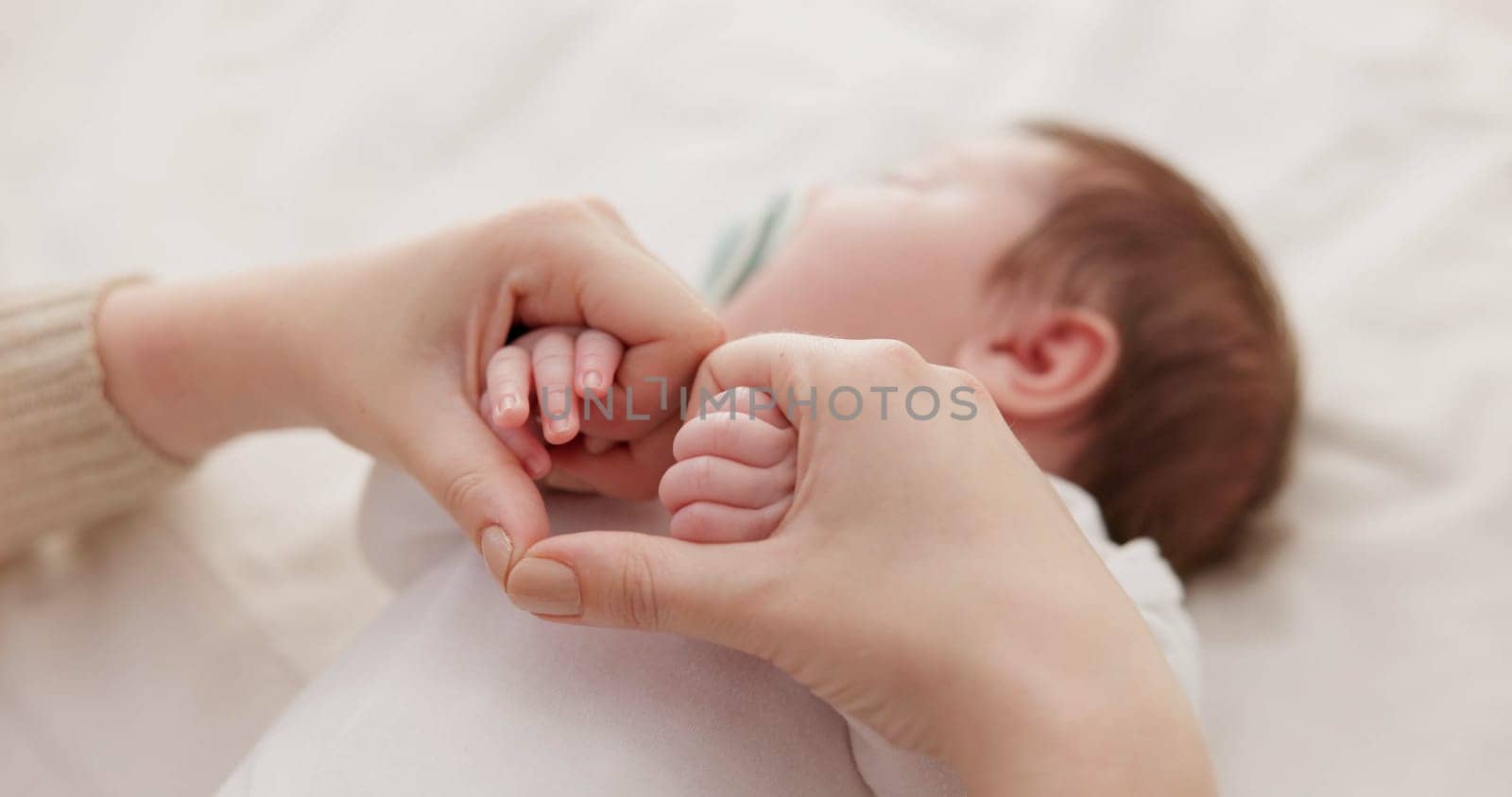 Bed, holding hands and mother with baby, love and support for care, health and wellness at home. Fingers, family or mama with a healthy infant, protection and child development with bond or maternity.