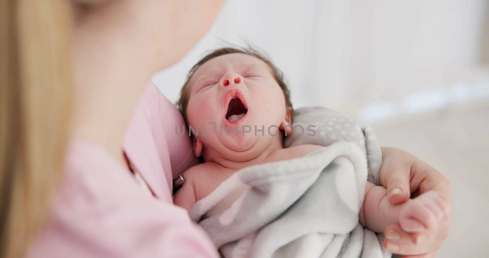 Baby, yawn and calm with tired newborn and mom in a bedroom at morning with care. Rest, relax and young kid with fatigue and mother support in a family home with motherhood in house with blanket.