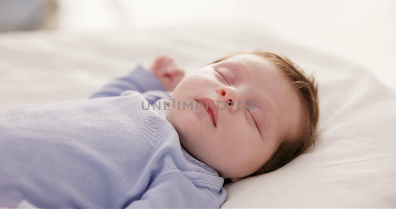 Relax, growth and sleep with a baby in a bedroom closeup in a home, dreaming during a nap for child development. Kids, calm and rest with an adorable newborn infant asleep on a bed for comfort.