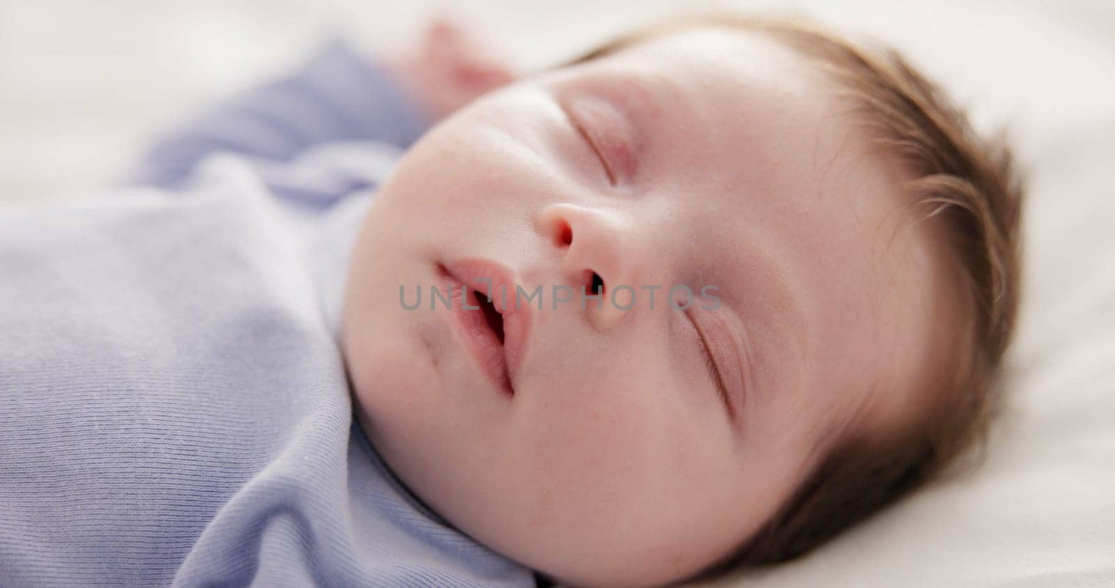 Face, relax and sleep with a baby on a bed closeup in a home, dreaming during a nap for child development. Growth, calm and rest with an adorable newborn infant asleep in a bedroom for comfort by YuriArcurs