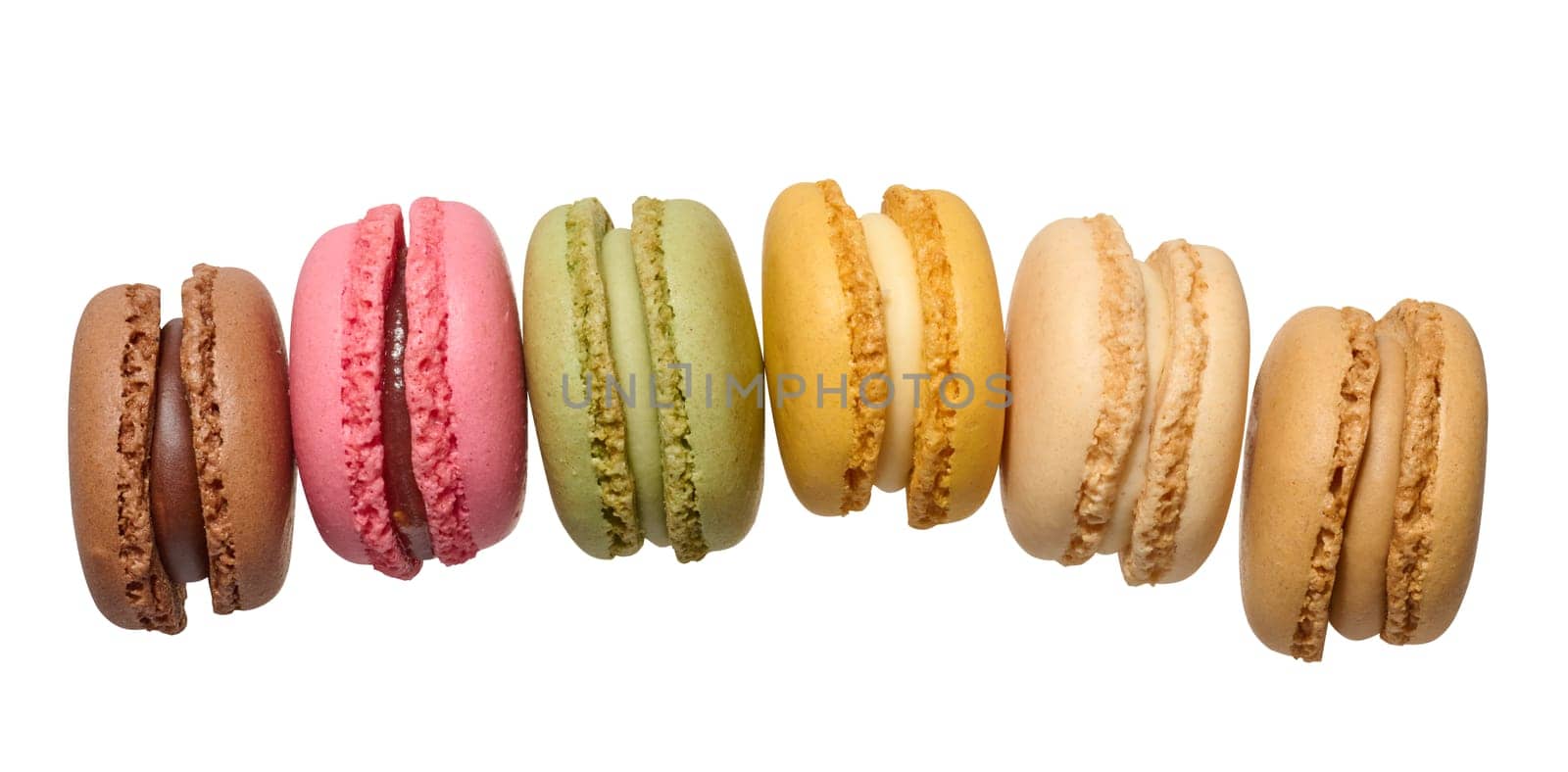 Multicolored baked macarons on isolated background by ndanko
