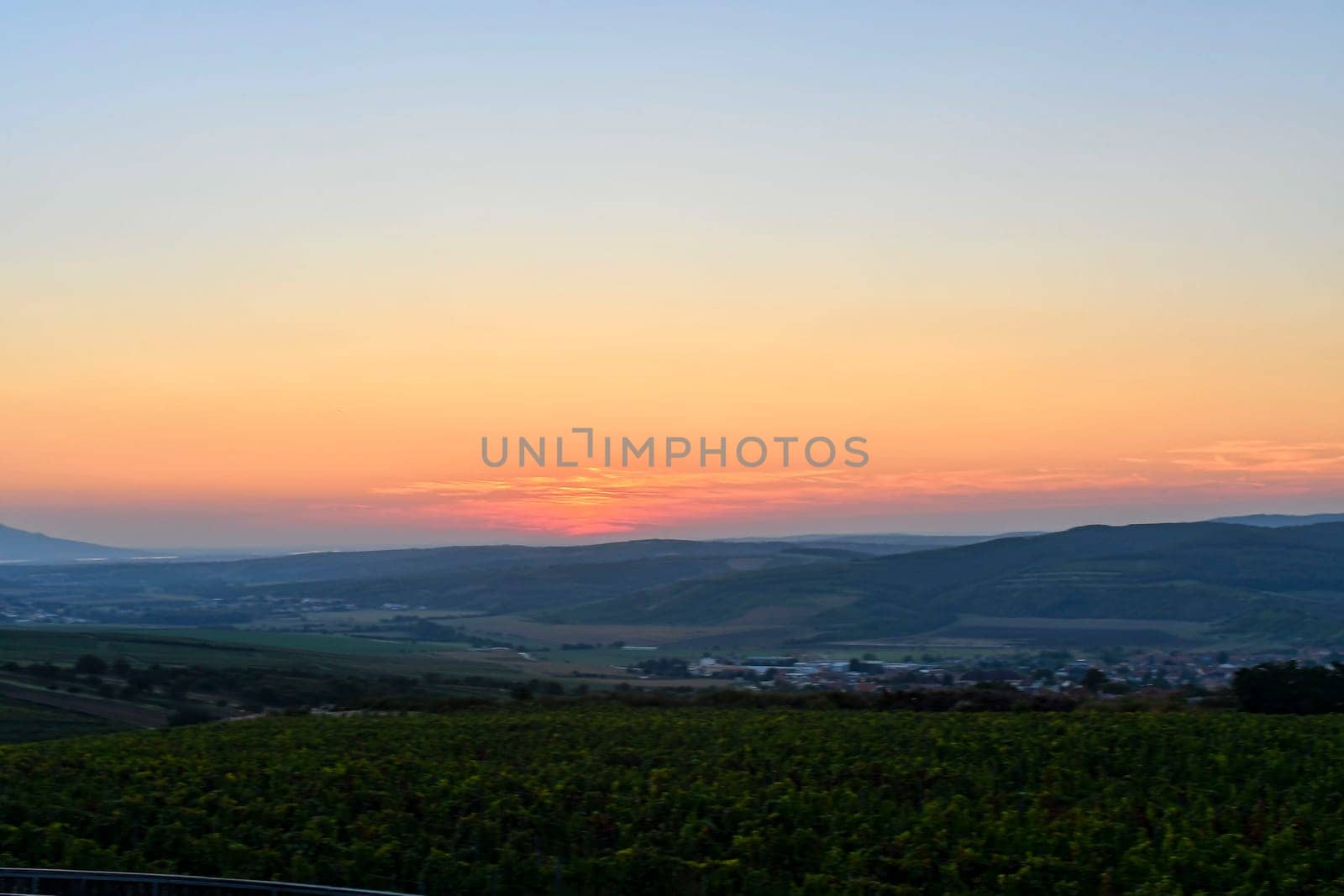 Landscape at twilight with red sky. Romantic sunset with the blush of dawn. Enchanting sunset with red clouds by roman_nerud