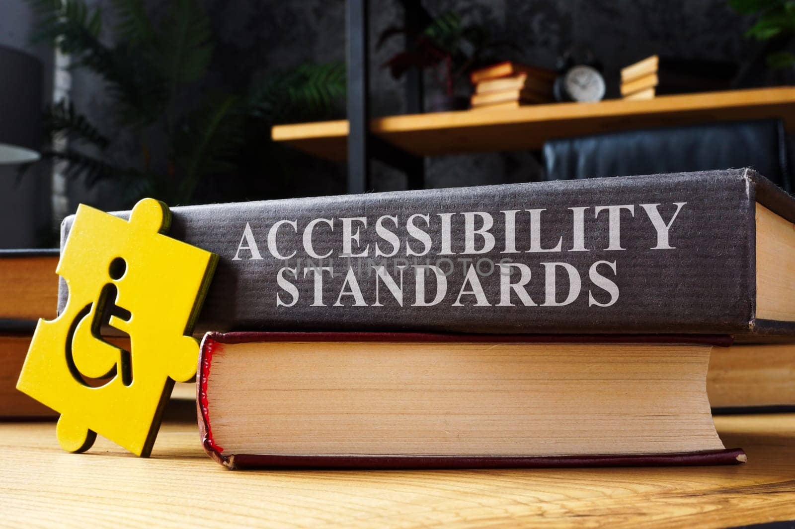 Accessibility standards book and disabled person sign. by designer491