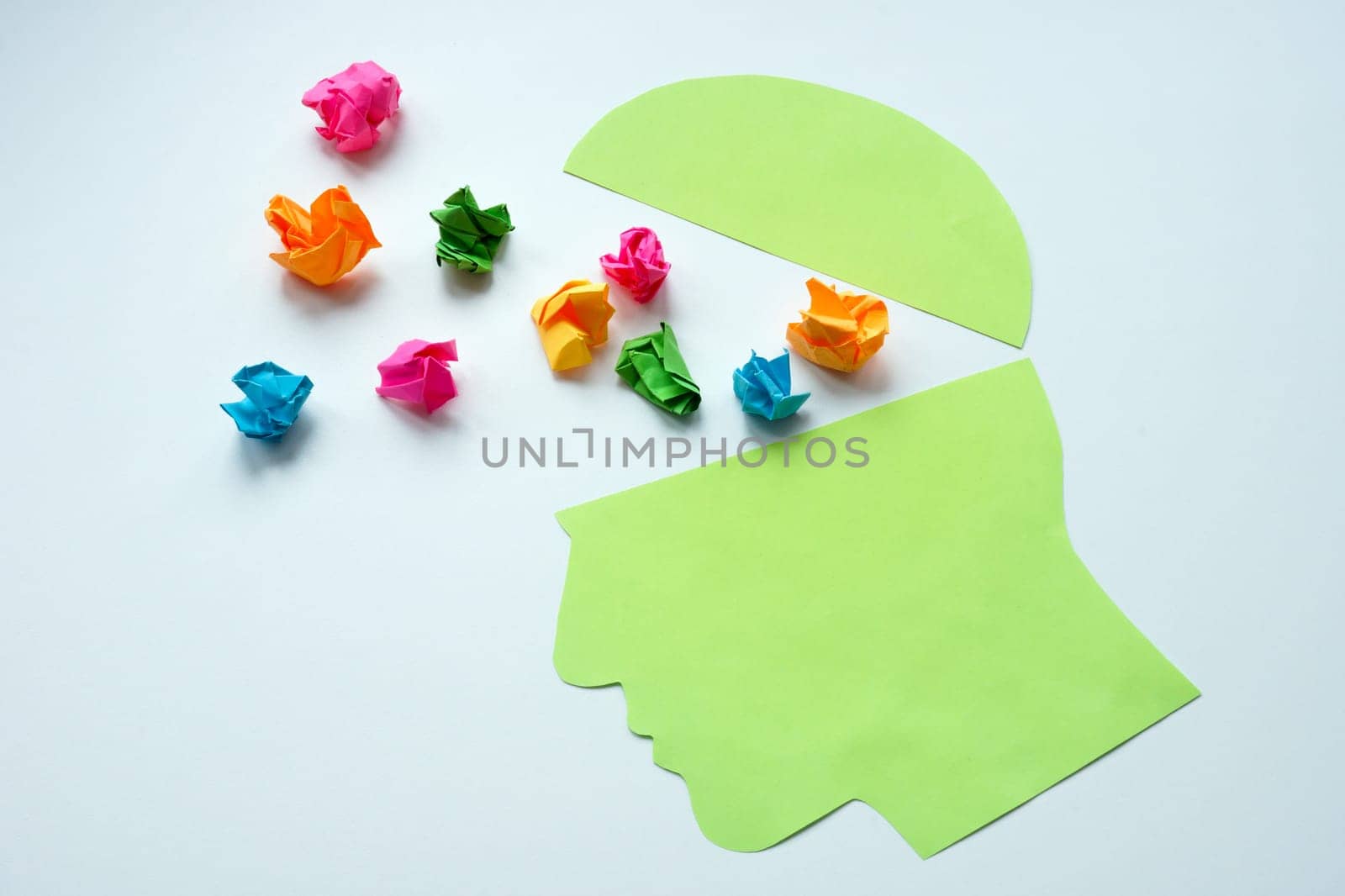 Head and small colored paper balls. Positive thinking concept.