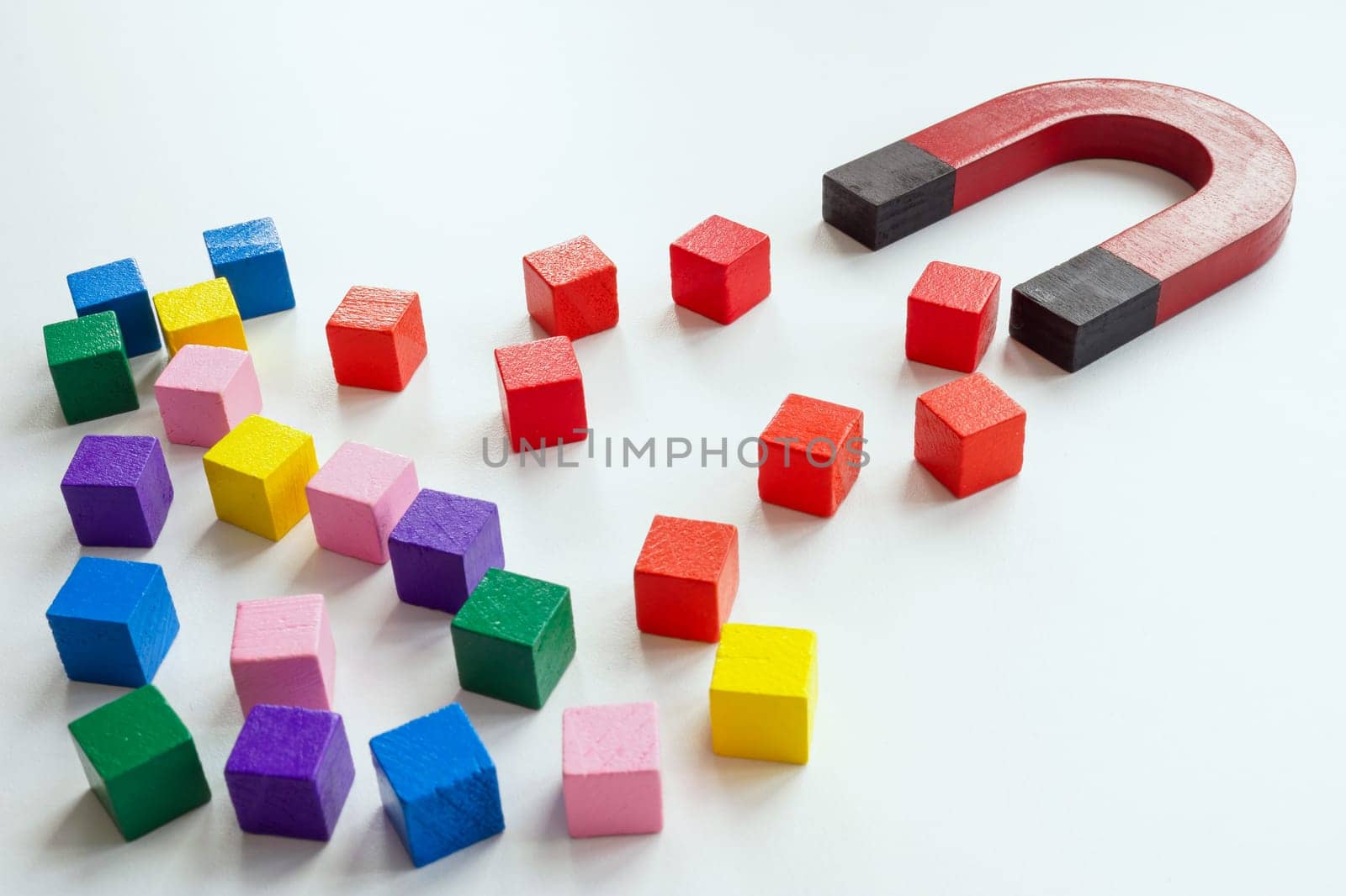 Talented employee or customer acquisition concept. The magnet attracts the red cubes. by designer491