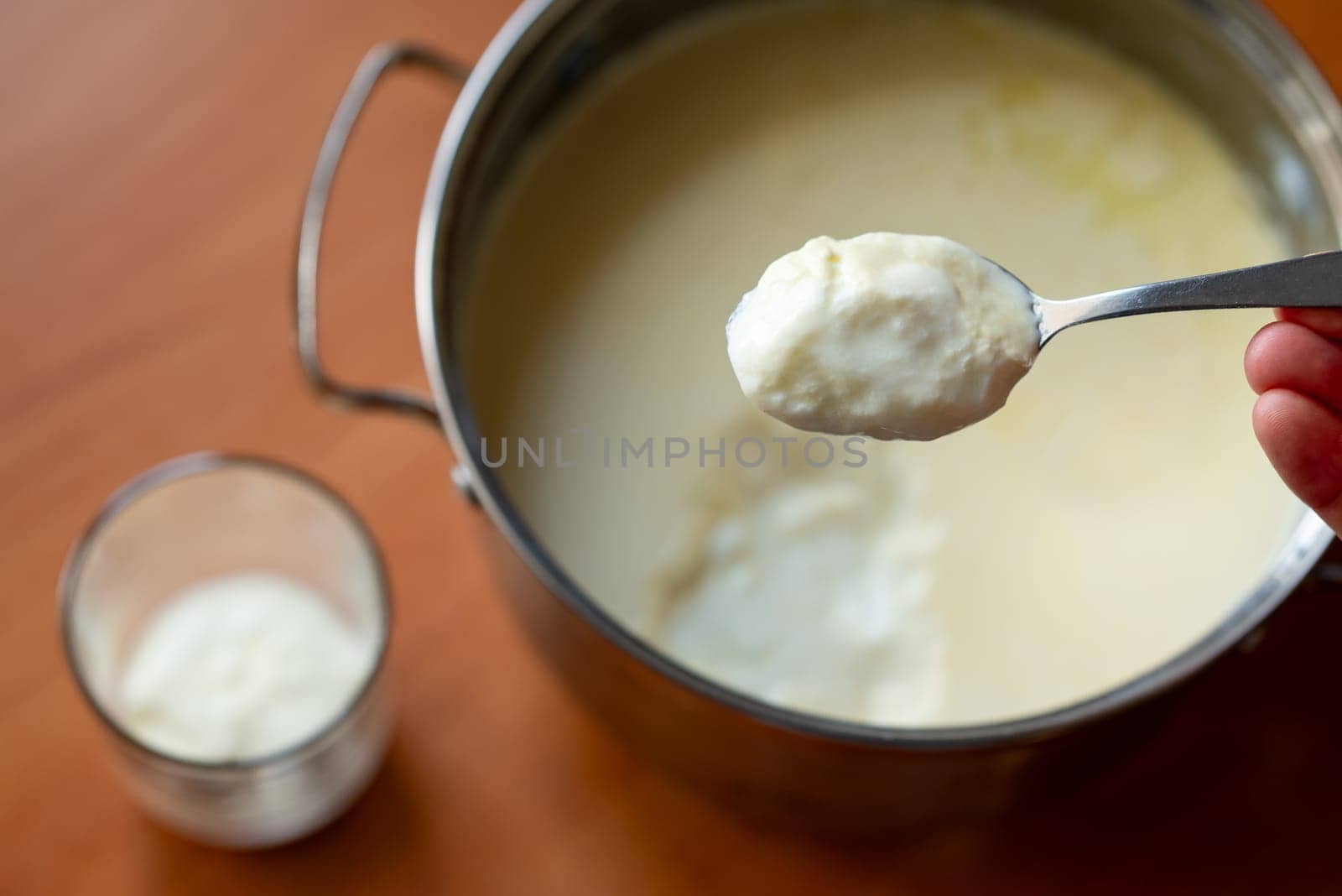 Pot with yogurt on the background, concept of homemade dairy product