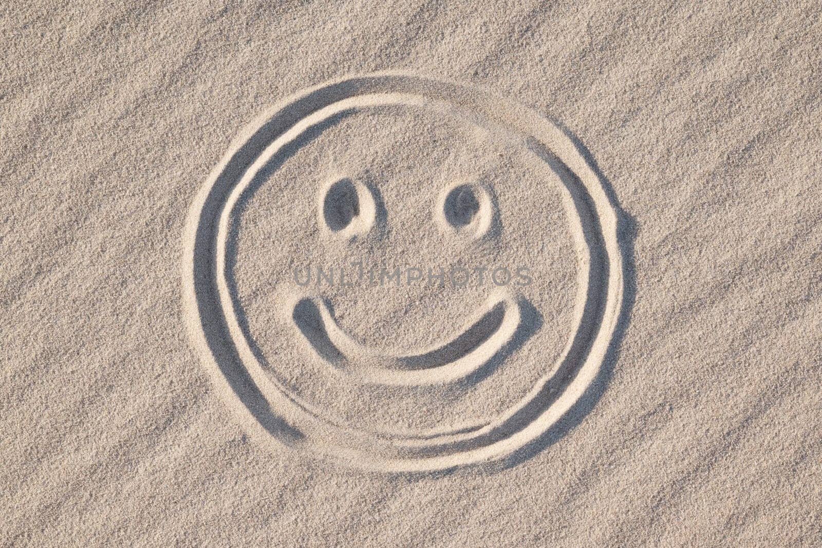 Happy smiley drawn on wavy sand, close up by VitaliiPetrushenko