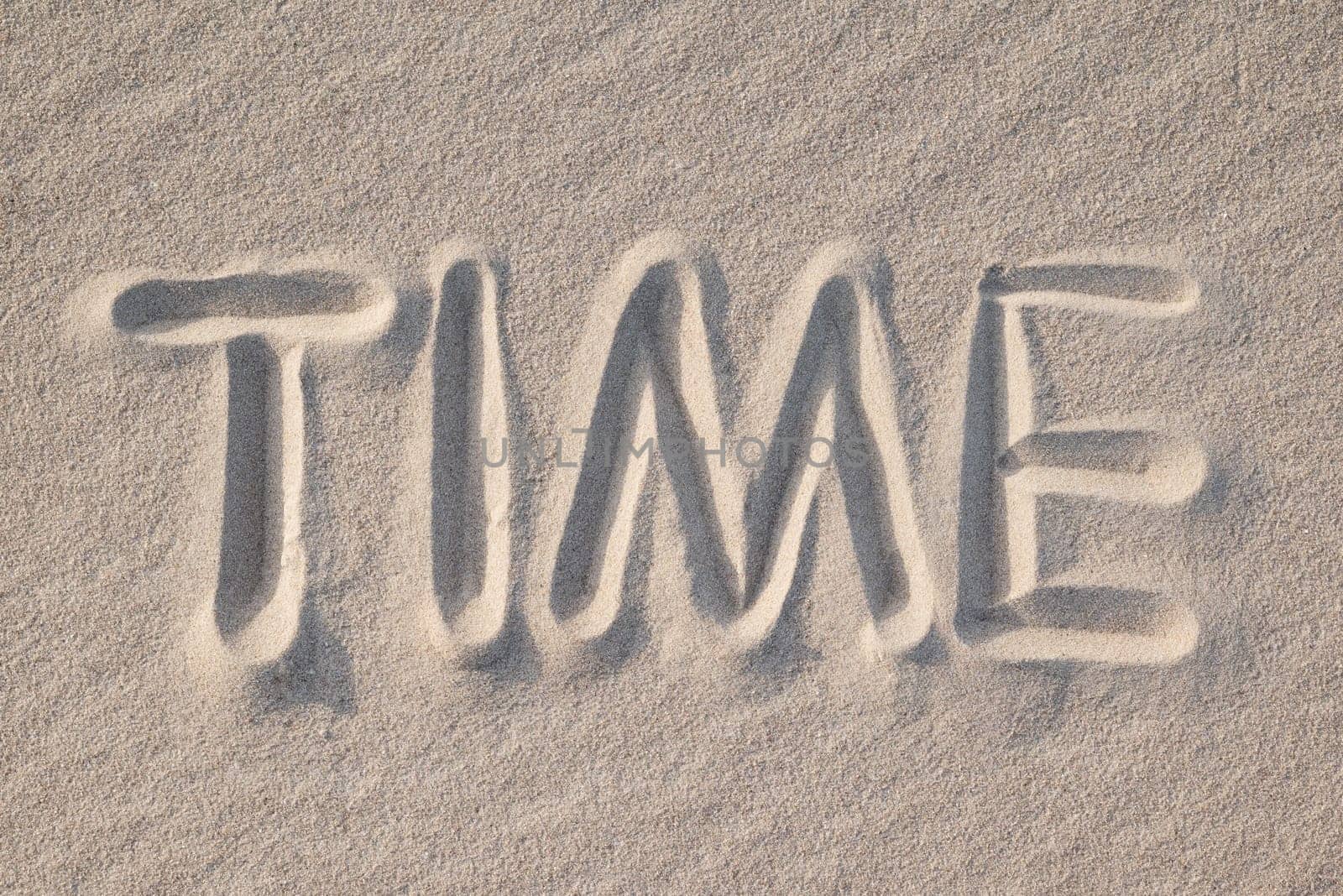 Word Time drawn on sand, close up by VitaliiPetrushenko