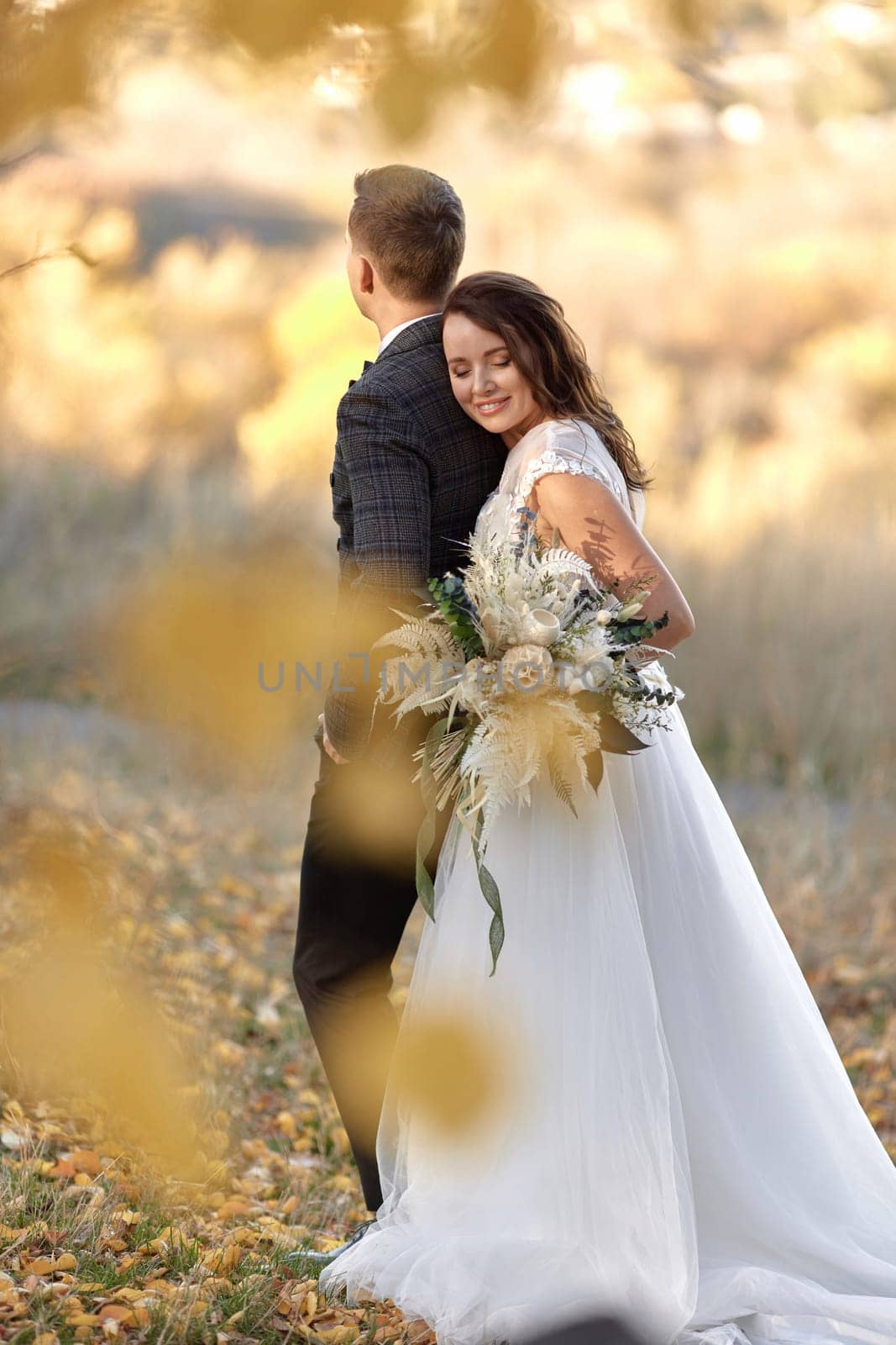 bride in white wedding dress and groom outdoor by erstudio