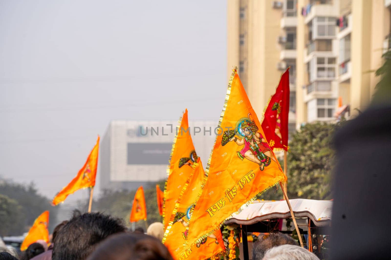 Crowd of people walking on Shobha yatra walk carrying flag celebrating the Pran Pratishtha consecration of Ram mandir temple massive celebration in India by Shalinimathur