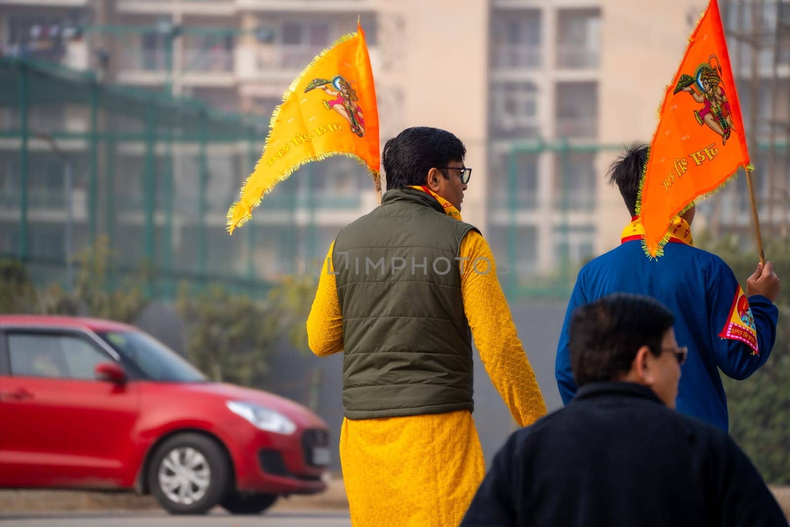 hindu devotee celebrating and carrying the flag celebrating the Pran Pratishtha consecration of Ram mandir temple massive celebration in India by Shalinimathur