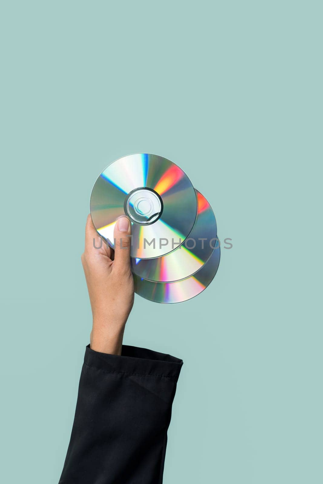 Businessman's hand holding electric CD on isolated background. Eco-business recycle waste policy in corporate responsibility. Reuse, reduce and recycle for sustainability environment. Quaint