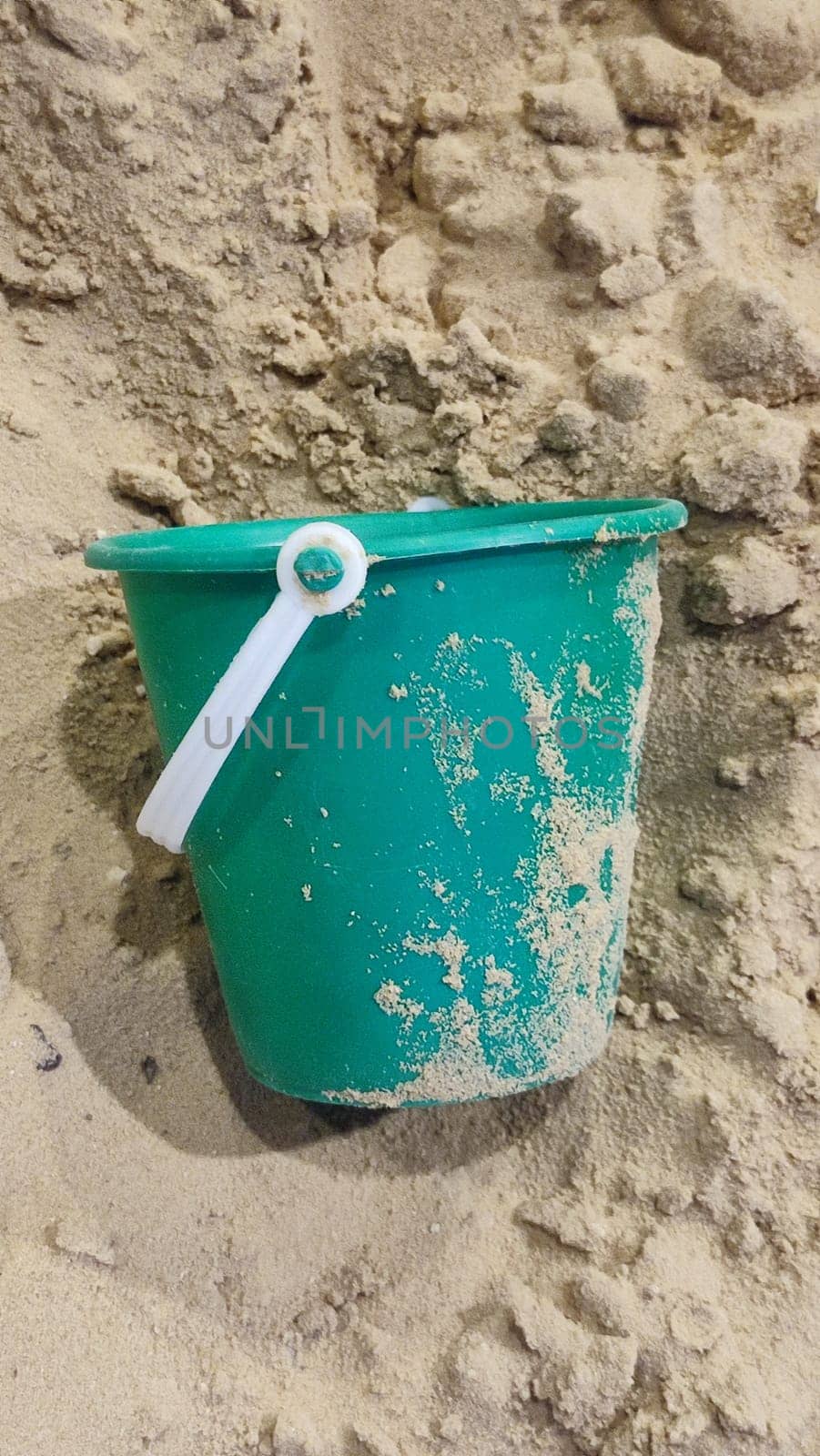 green plastic bucket lies in the sand, children's toy, object, beach by Ply