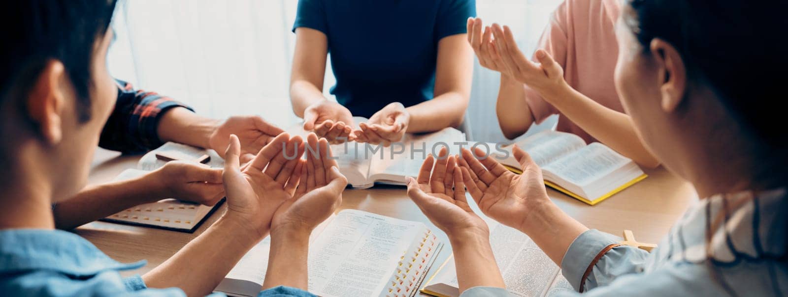 Diversity people hand praying faithfully together on bible book. Burgeoning. by biancoblue