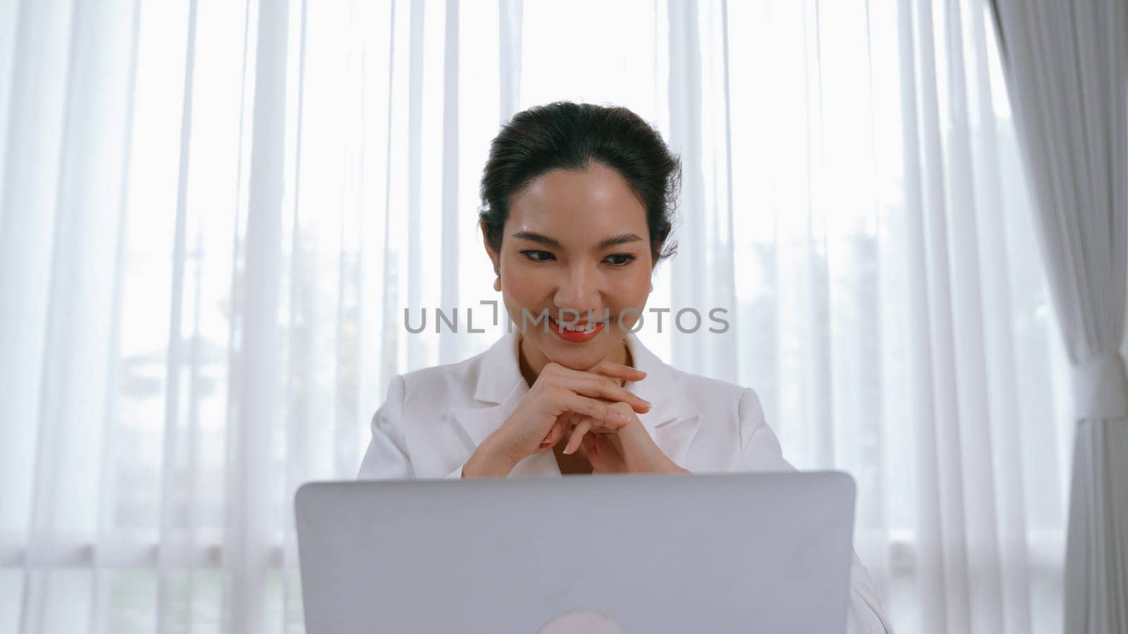 Young businesswoman sitting on the workspace desk using laptop. Vivancy by biancoblue