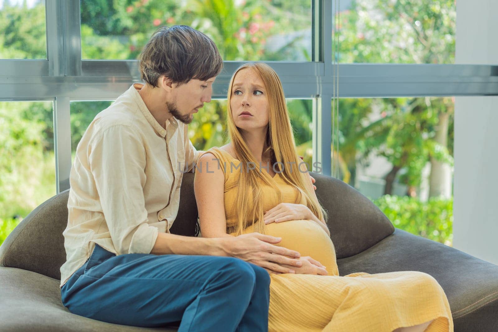 Expectant woman feels unwell, husband comforts and reassures her during a challenging pregnancy by galitskaya