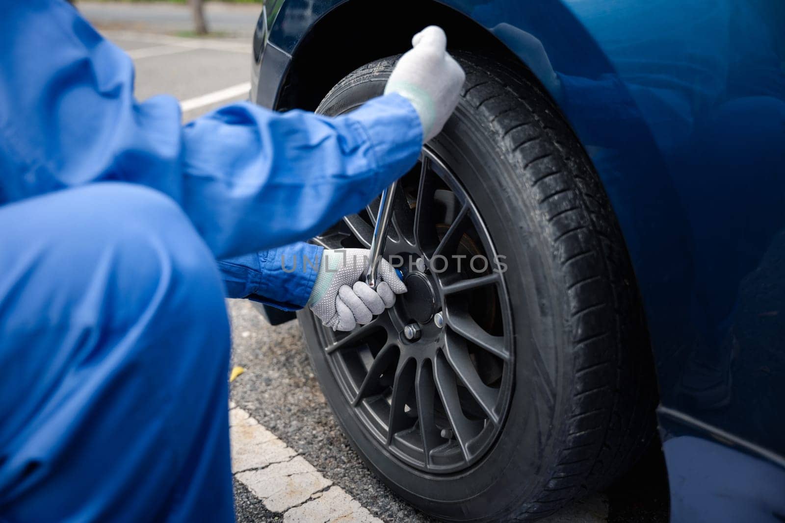 Man mechanic changing wheels after car breakdown. by Sorapop