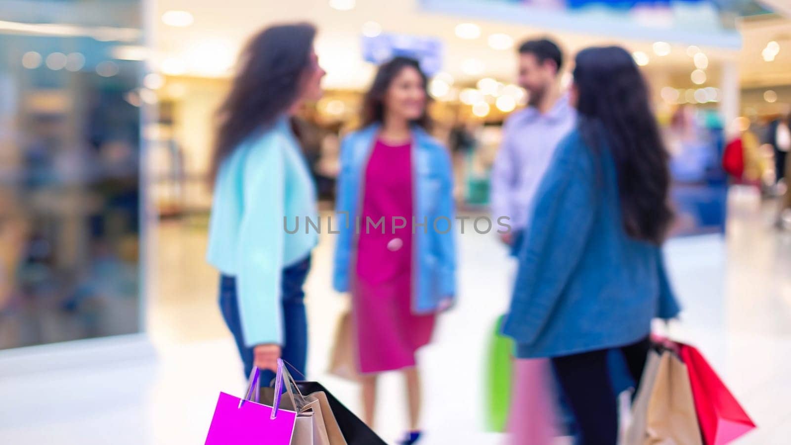 sale, consumerism and people concept - blurred happy young women with shopping bags walking in mall. High quality image