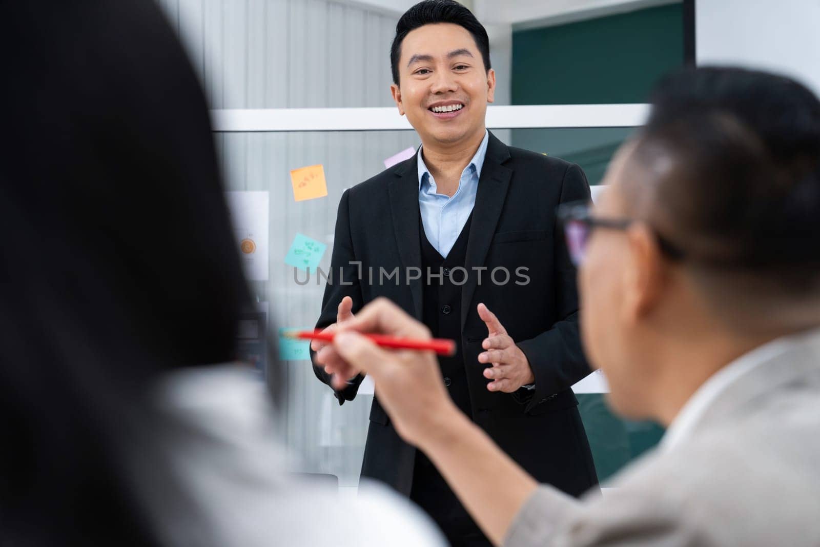 Successful businessman presents his financial plan and data analyst with confident. Group of executive managers asking questions. Office Conference room meeting. Board room. Intellectual.