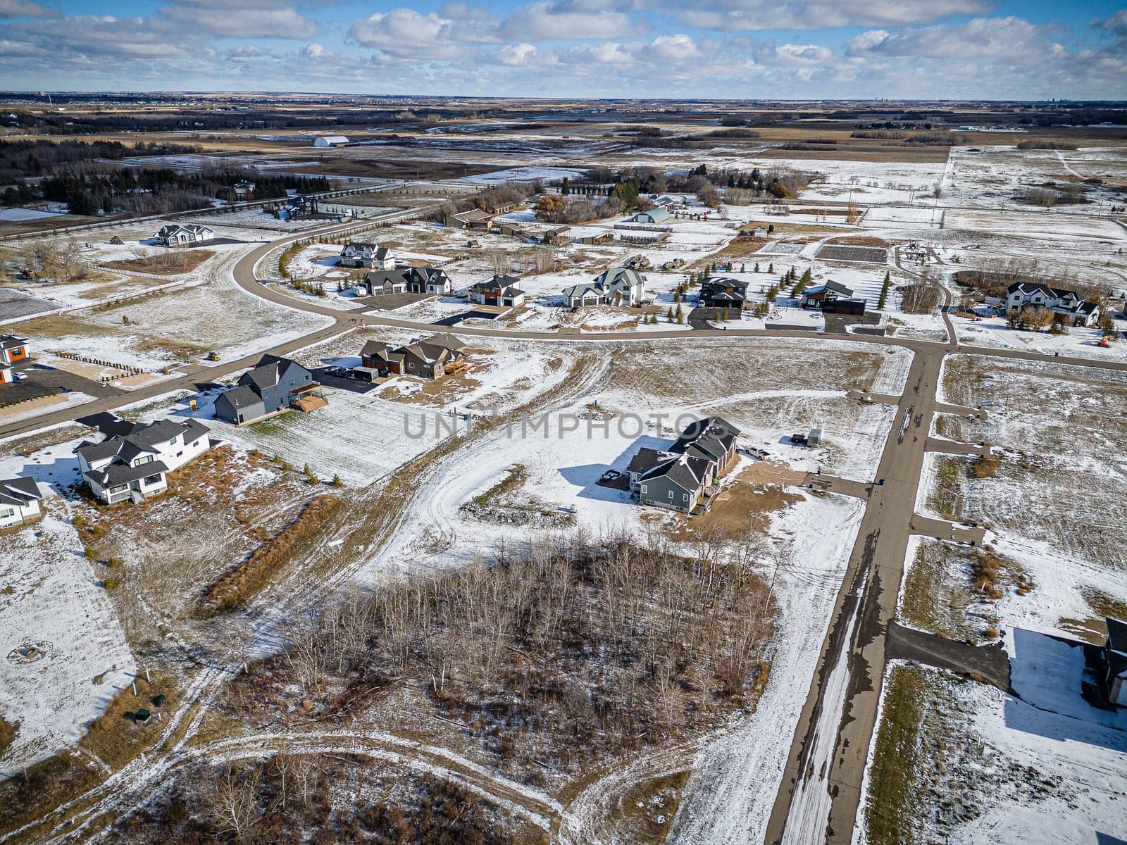 Drone image showcasing the beauty of Grasswood Estates in Saskatoon, Saskatchewan, with its spacious residential properties and natural surroundings
