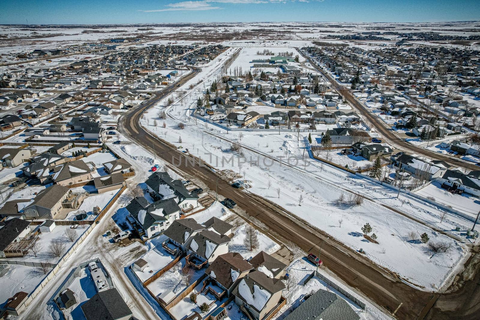 Drone image capturing the town of Martensville in Saskatchewan during the winter season, with its snow-covered streets, cozy homes, and charming winter scenery