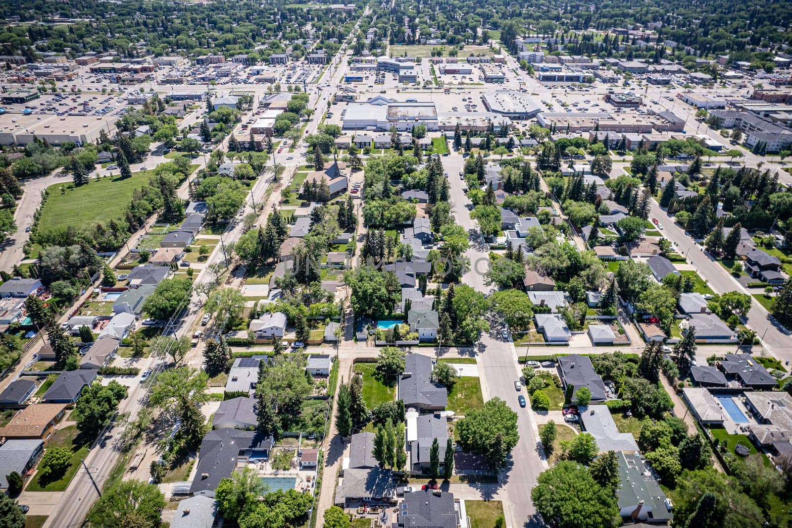 Drone image showcasing the charm of Grosvenor Park, Saskatoon, with its residential areas, greenery, and community spaces.