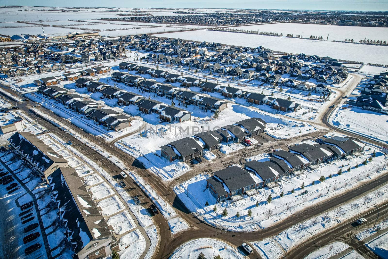Drone capture of Evergreen, Saskatoon, highlighting its unique layout and lush green spaces.